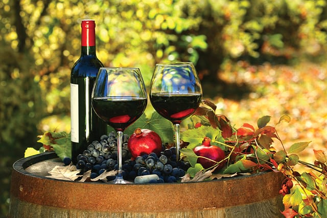 State College - Glasses of red wine on old barrel