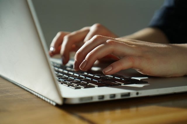State College - Woman types on keyboard