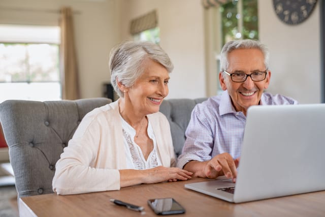 State College - Senior couple using laptop