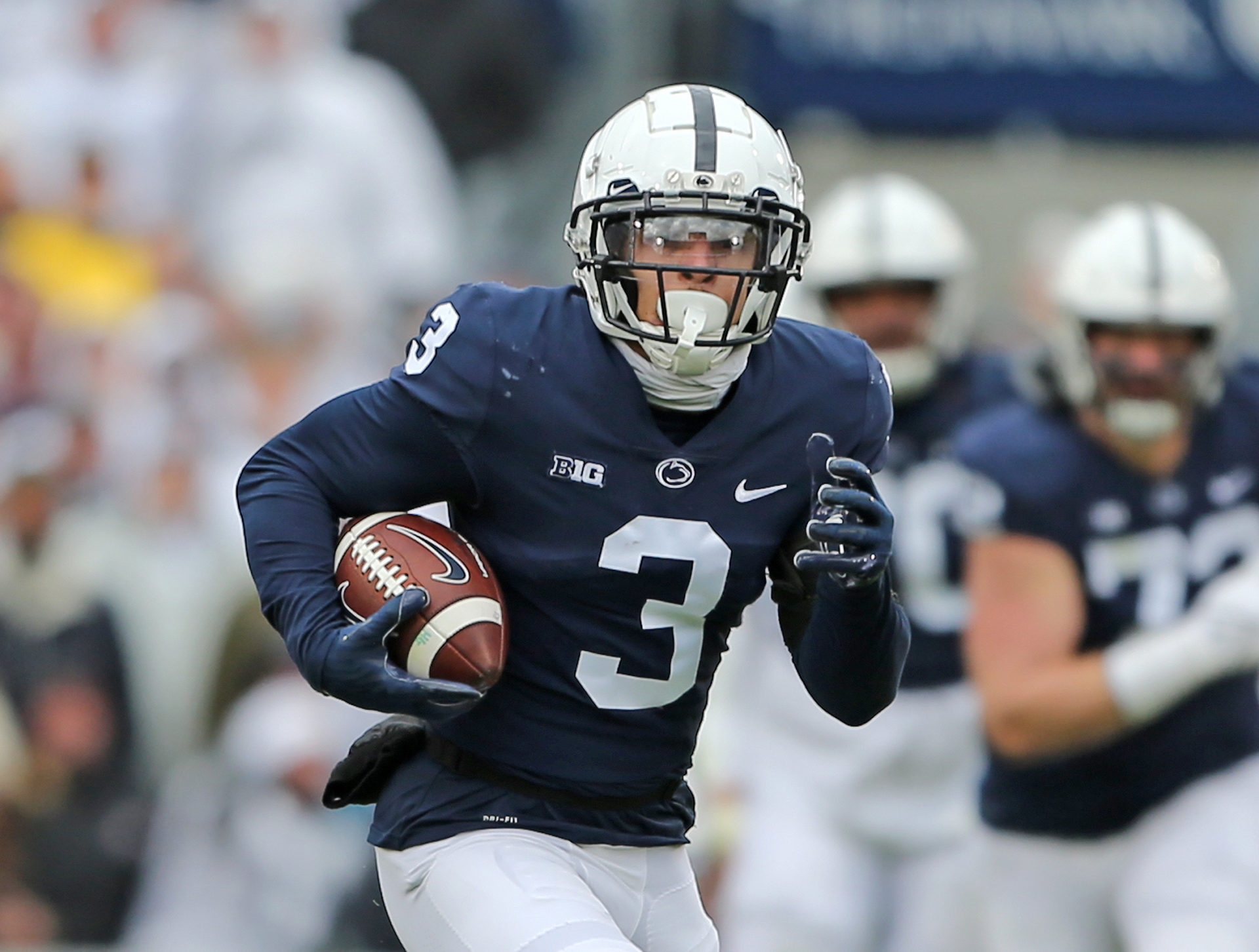 Penn State Wide Receiver, Parker Washington, running in open field with the ball in the right hand. 