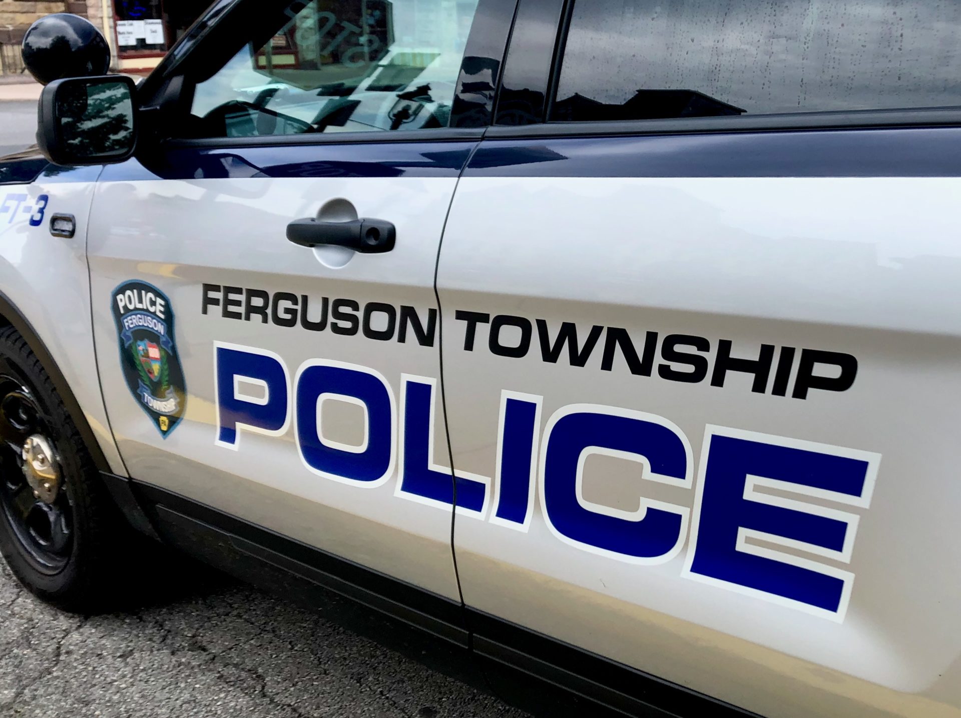 "Ferguson Township Police" on the side doors of a gray police SUV.