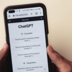 chat gpt interface on a mobile phone held by two hands