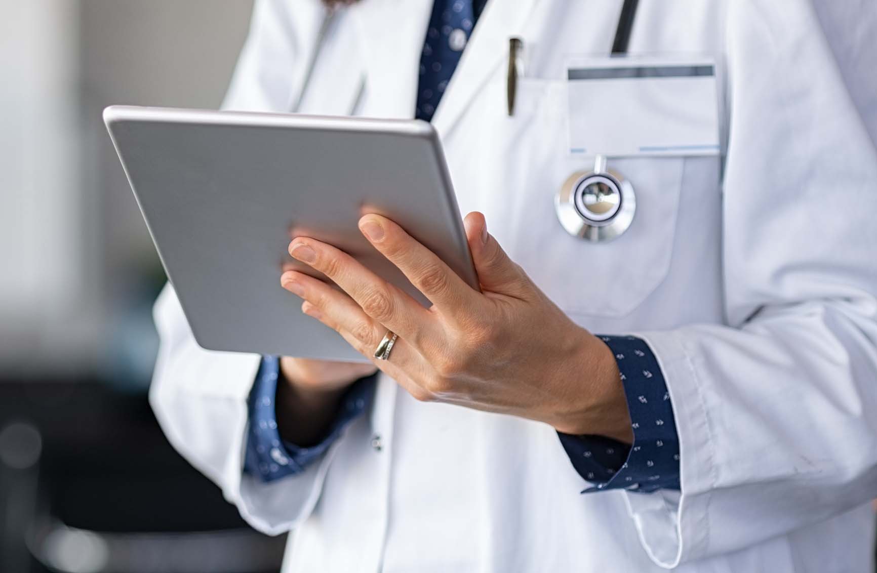 State College - Doctor using digital tablet