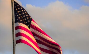 State College - american flag meadow-marie-eQ1xDfI79f0-unsplash