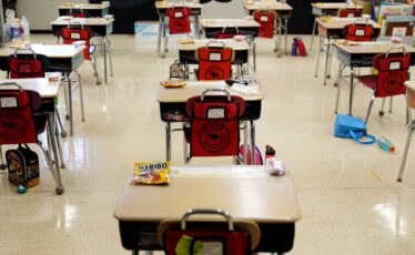 FILE - Desks are arranged in a classroom at an elementary school in Nesquehoning, Pa., March 11, 2021. The COVID-19 pandemic that shuttered classrooms set back learning in some U.S. school systems by more than a year, with children in high-poverty areas affected the most, according to a district-by-district analysis of test scores shared exclusively with The Associated Press. (AP Photo/Matt Slocum, File)
