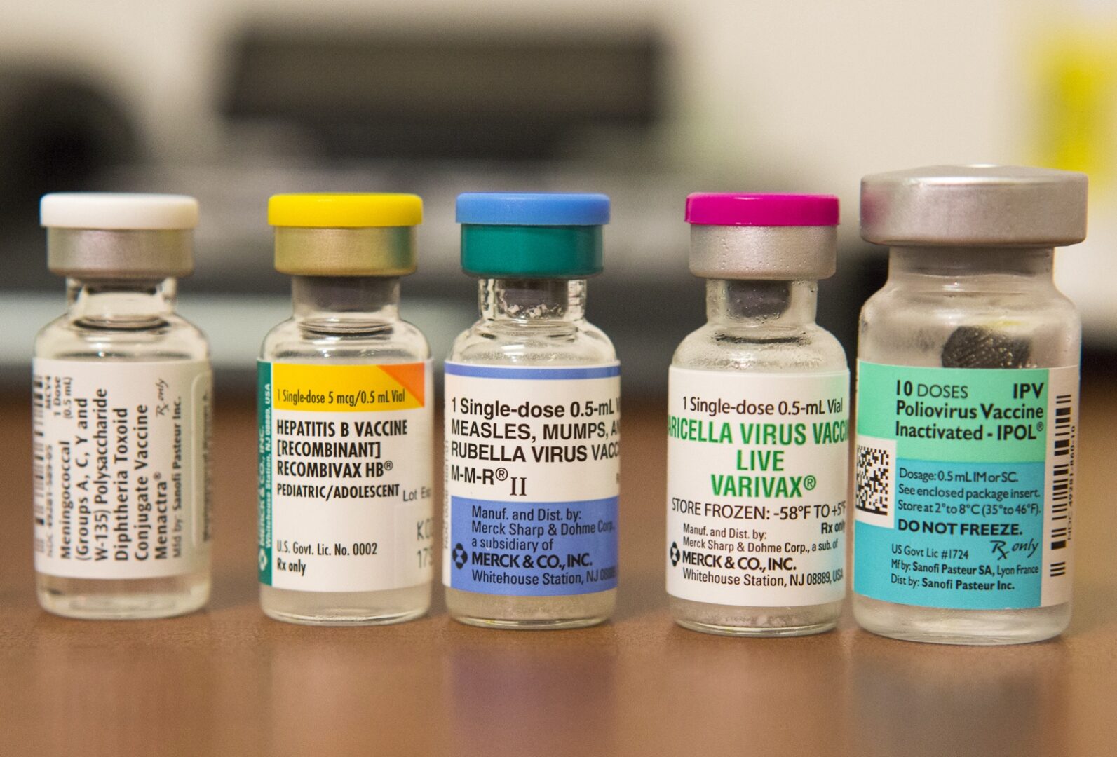 Vials containing vaccines for measles, hepatitis B, polio, and other diseases.