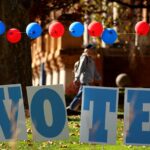 Students on the campus of the University of Pittsburgh in the Oakland neighborhood walk past a ‘vote’ sign on Election Day on November 5, 2024 in Pittsburgh, Pennsylvania.