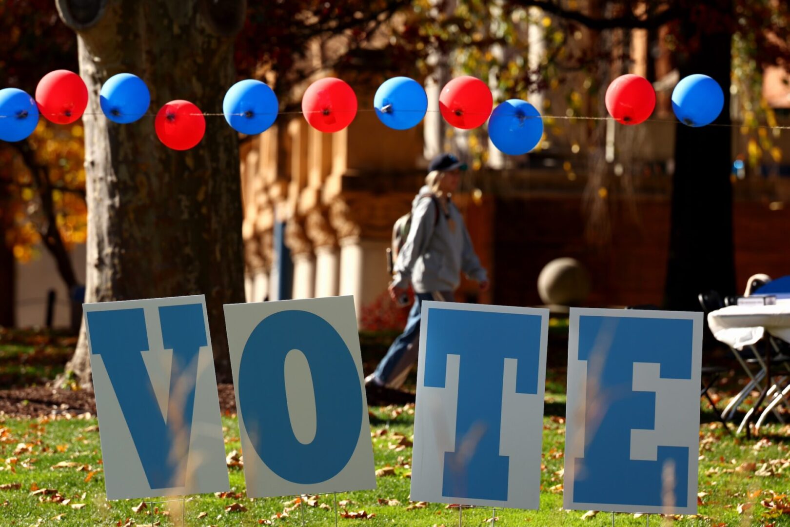 Students on the campus of the University of Pittsburgh in the Oakland neighborhood walk past a ‘vote’ sign on Election Day on November 5, 2024 in Pittsburgh, Pennsylvania.