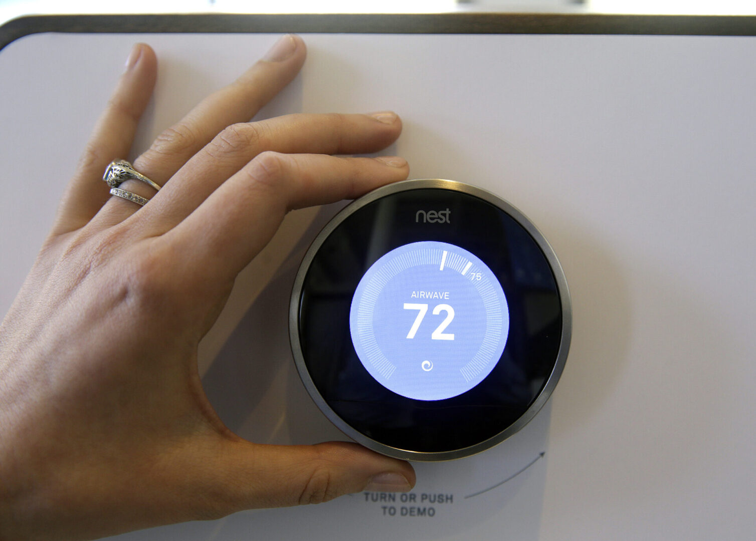 The Nest Learning Thermostat is on display following a news conference Wednesday, June 17, 2015, in San Francisco. Google's Nest Labs is releasing new versions of its surveillance video camera and talking smoke detector as part of its attempt to turn homes into yet another thing that can be controlled and tracked over the Internet