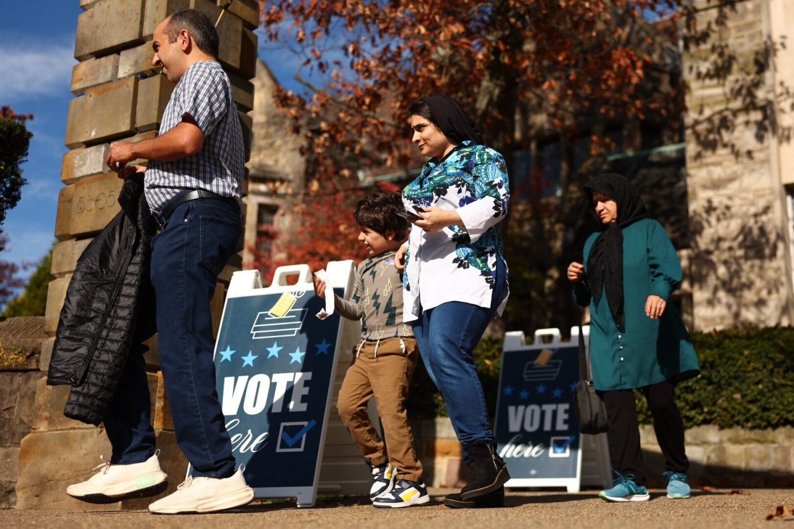 Voters walk past ‘Vote Here’ signs in front of Temple Sinai in the Squirrel Hill neighborhood on Election Day on November 5, 2024 in Pittsburgh, Pennsylvania.