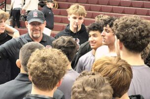 Coach Jason Nickal enjoys his team’s post-match huddle after the Little Lions victory over Williamsport. Photo by Bill Horlacher