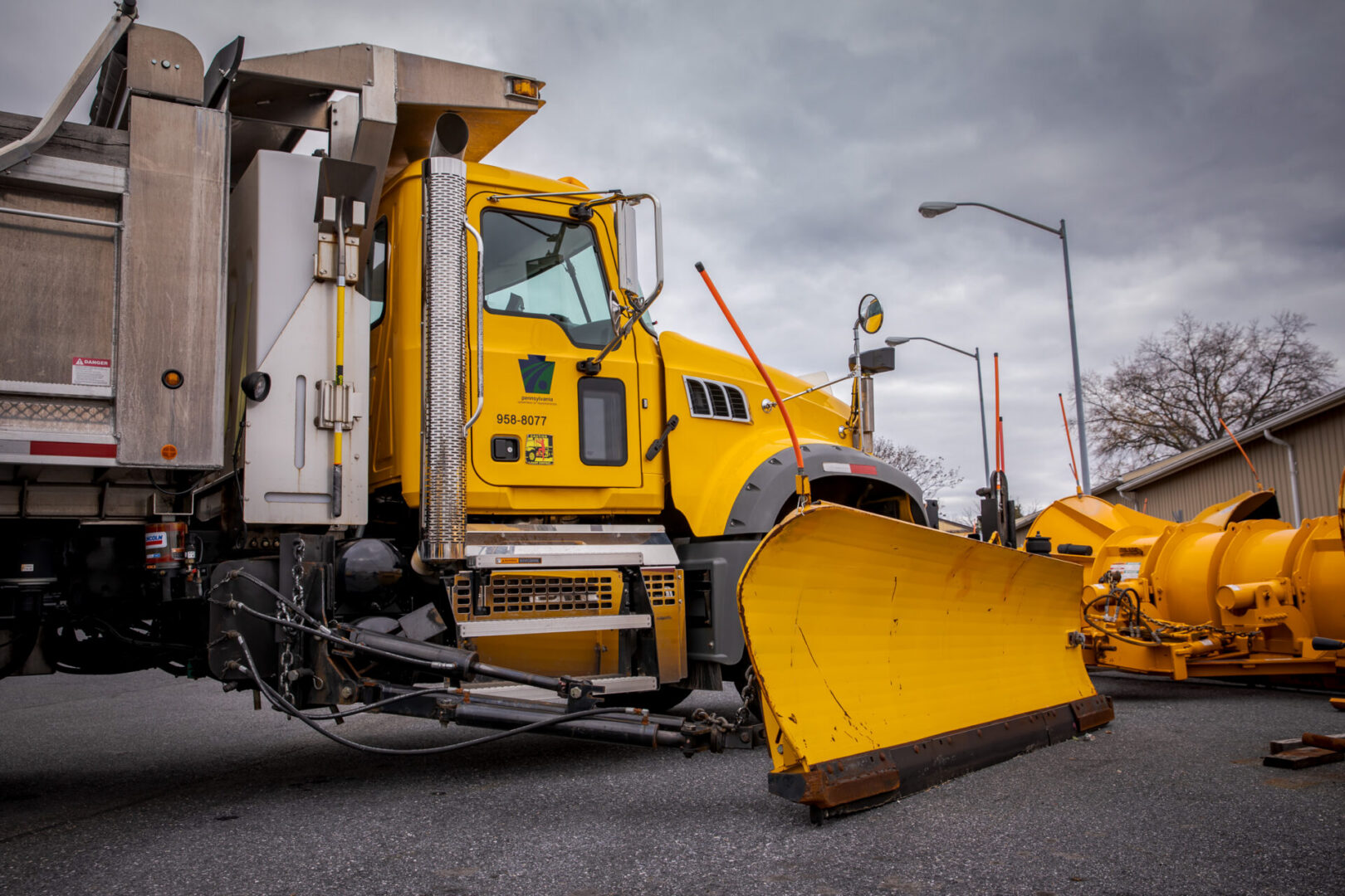 A PennDOT snow plow in a parking lot