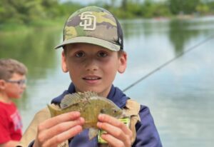 family-fishing-picnic-boy-with-blue-gill-768×528