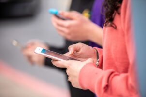 A person holds a cellphone in their hands