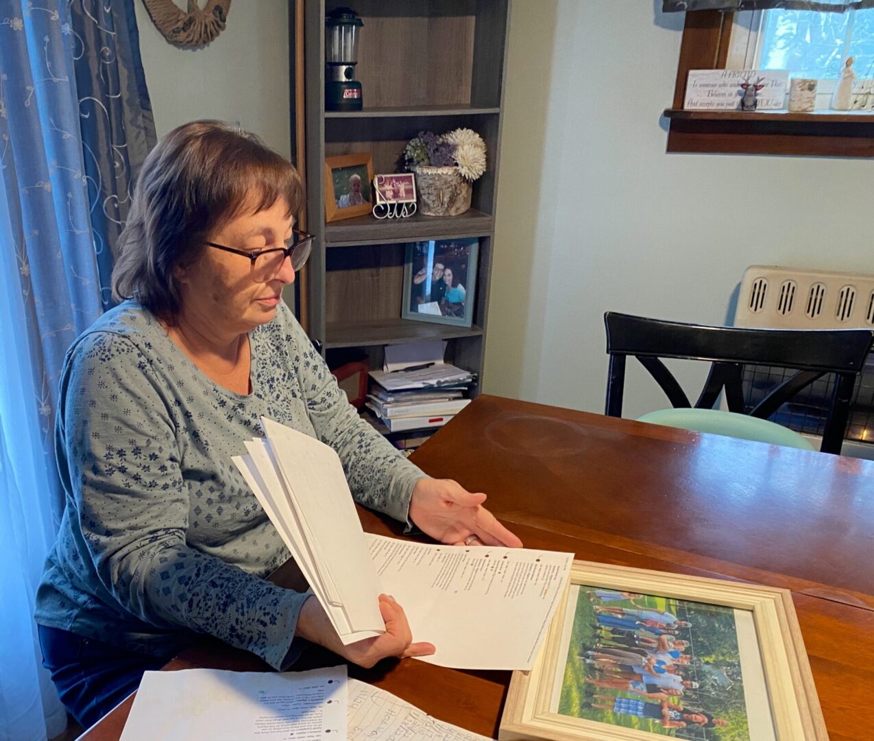 Cyndi Compton looks through papers in her Tioga County home.