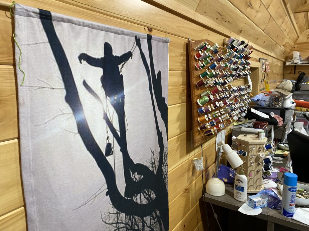 A large piece of fabric, showing Isaiah Compton in a tree, hangs in a backyard shed at Cyndi Compton's Tioga County home.