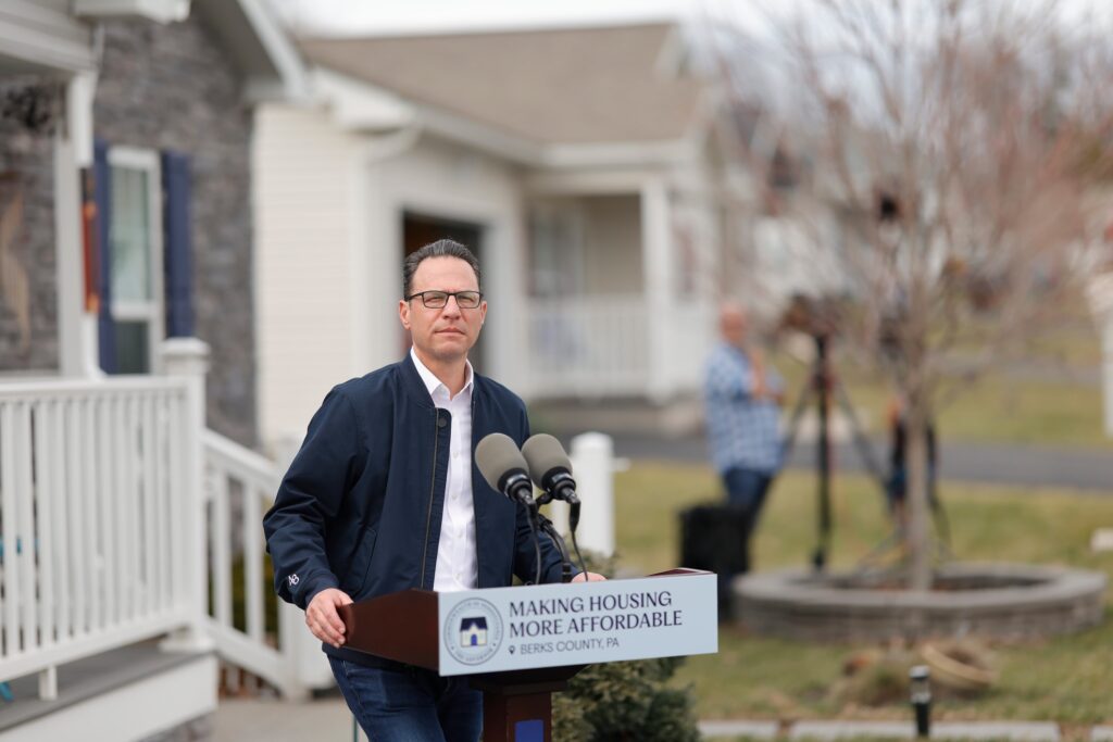 Gov. Josh Shapiro stands behind a podium that says “Making Housing More Affordable.”